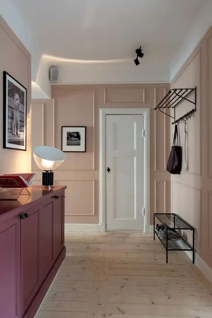 A welcoming foyer painted in soft blush pink