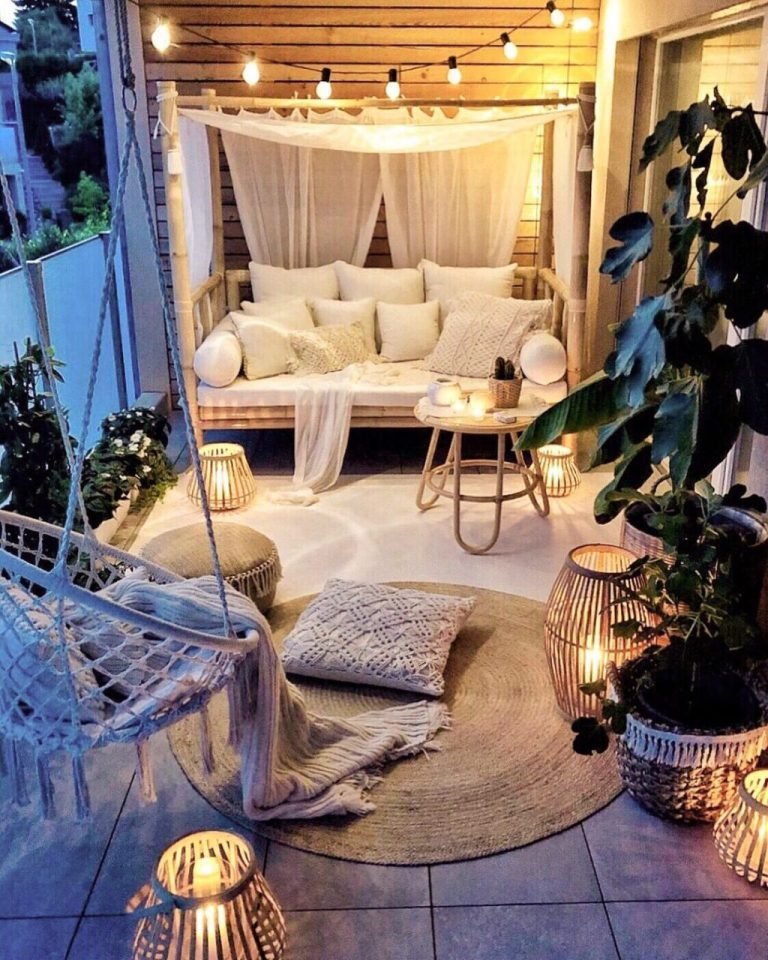Cozy coastal balcony seating area with cushions and throws
