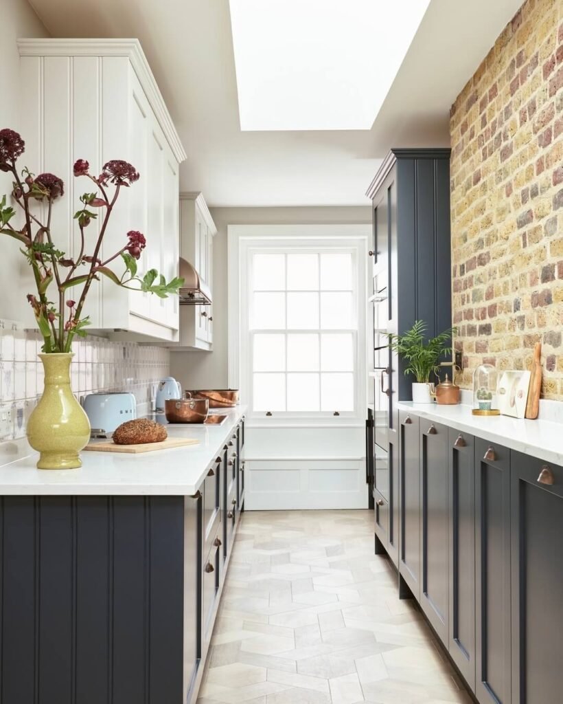 1. Sophisticated Navy with Marble Waterfall Island