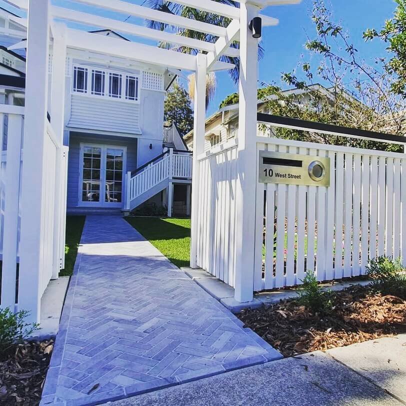 10. Herringbone Pavers Under a Coastal Arbor