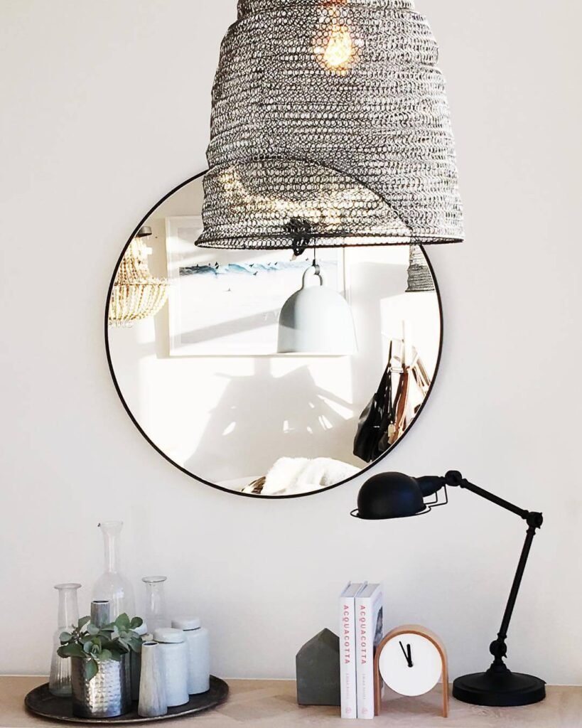 12. Minimal Round Mirror with Industrial Accents