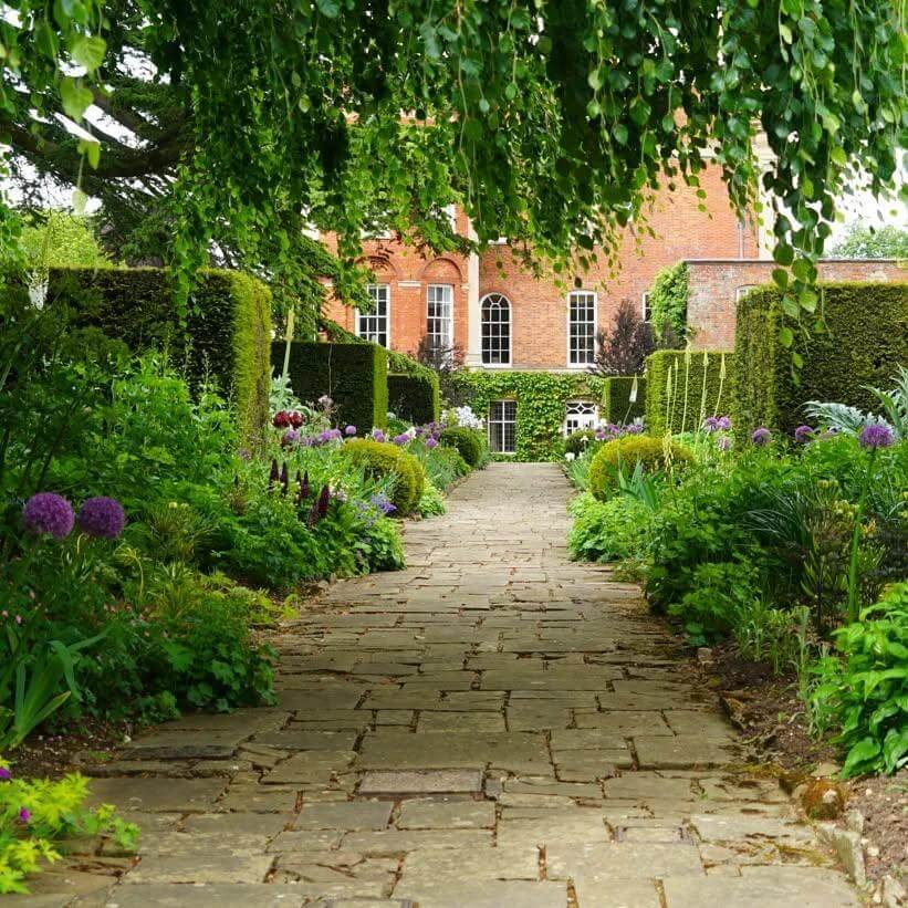 7. Formal Stone Walkway Framed by Manicured Borders