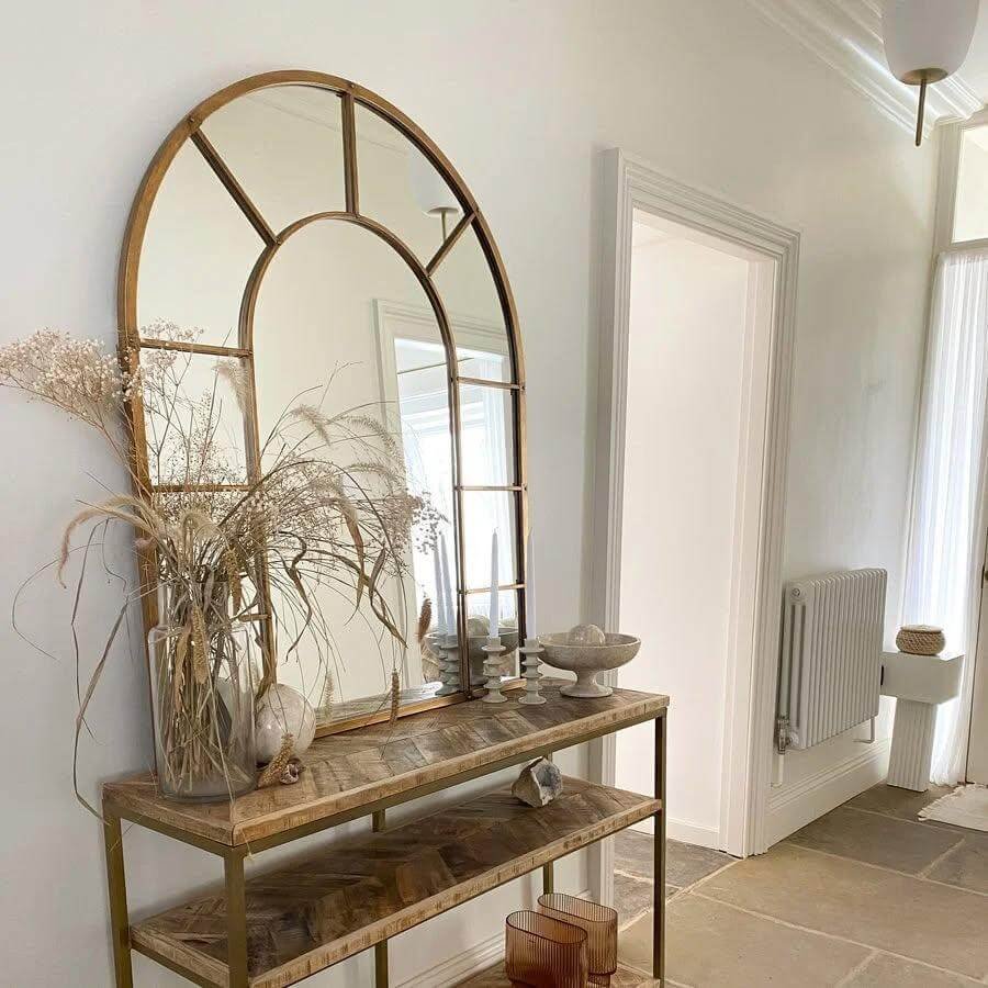 8. Rustic Arch Mirror with Natural Wood