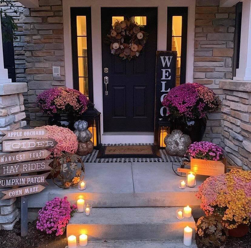 1. Layered Porch Decor With Mums Lanterns Candlelight Magic