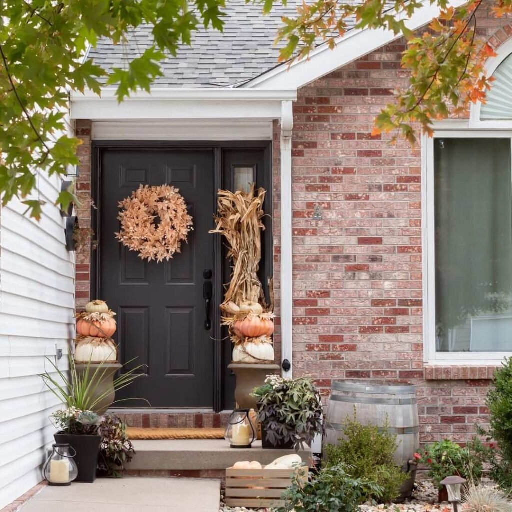 12. Rustic Harvest Entrance with Cornstalks and Stacked Pumpkins