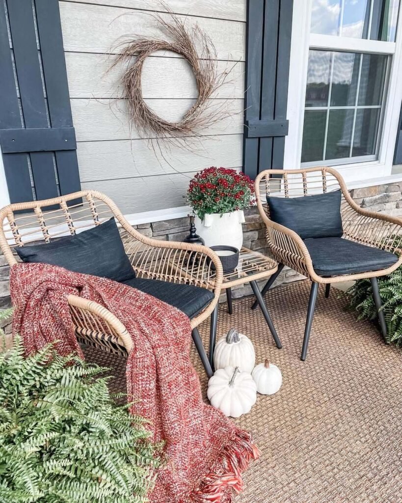 17. Laid Back Porch Nook with Cozy Layers and White Pumpkins