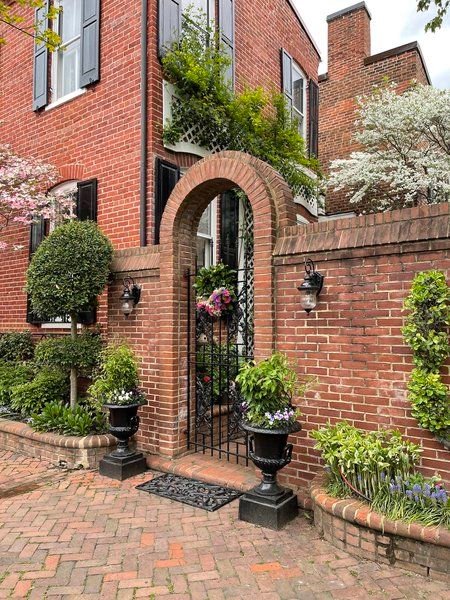 Red Brick Exterior with Statement Fence for Privacy and Style